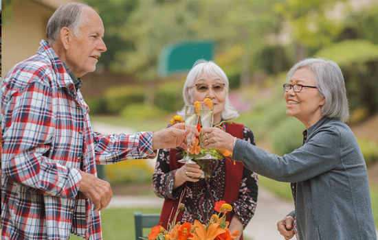 Senior residents toast glasses at Summerfield of Stockton Memory Care in Stockton, CA