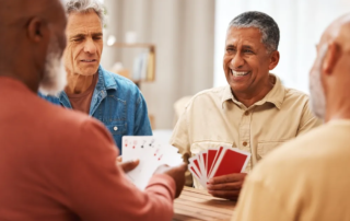 Senior man, friends and playing card games on wooden table
