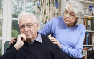 Woman Comforting Senior Man With an Unhappy Look