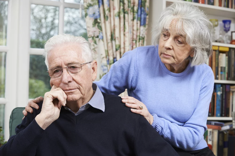 Woman Comforting Senior Man With an Unhappy Look
